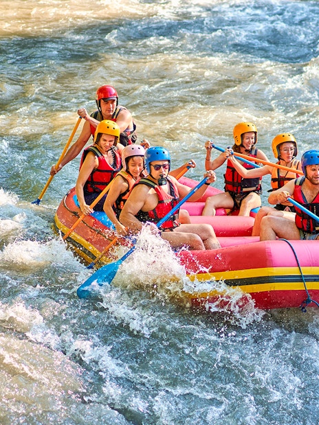 White water rafting group navigating rapids in Bali.