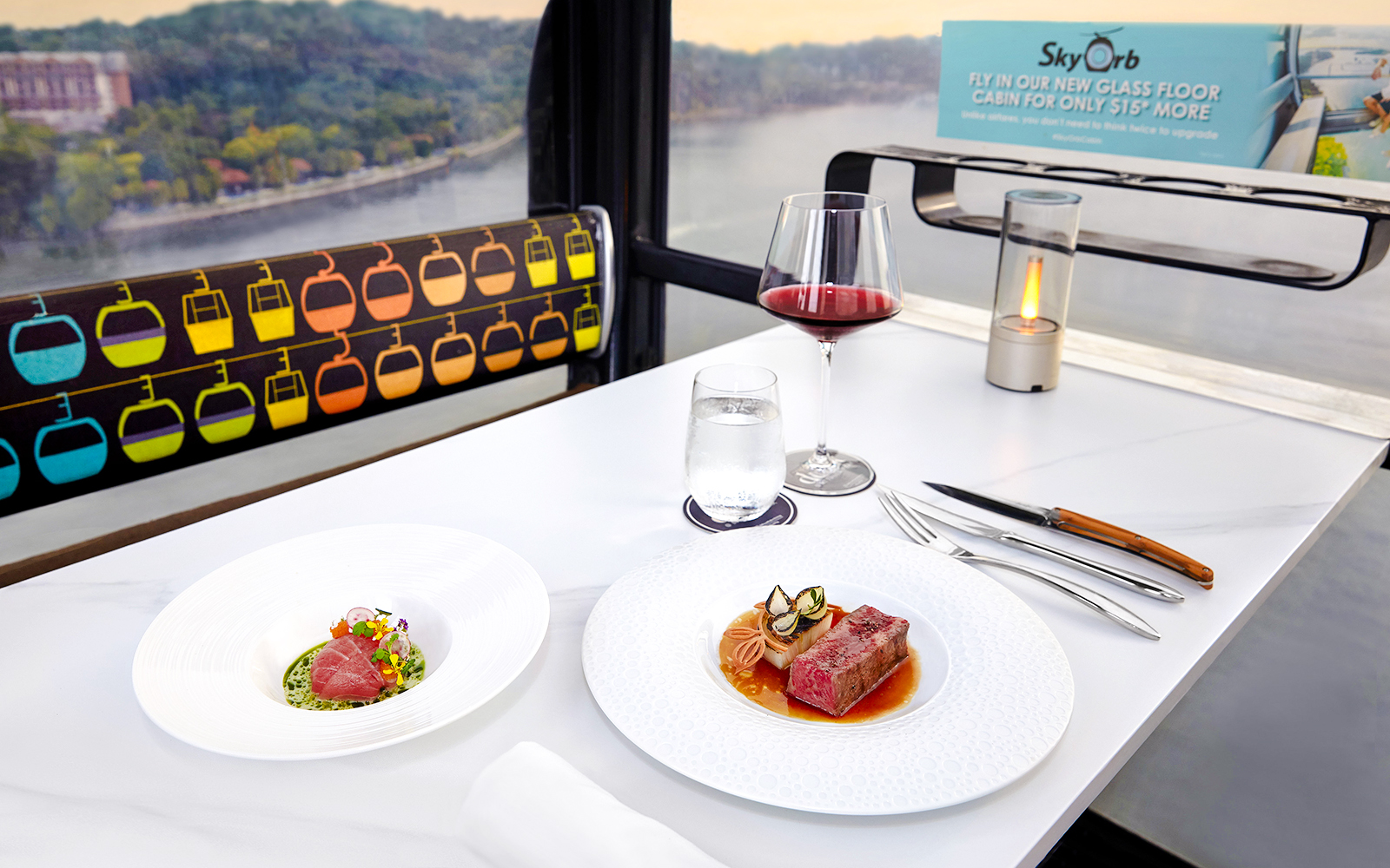 Singapore cable car dining with dishes by Chef Mathew Leong, overlooking cityscape.
