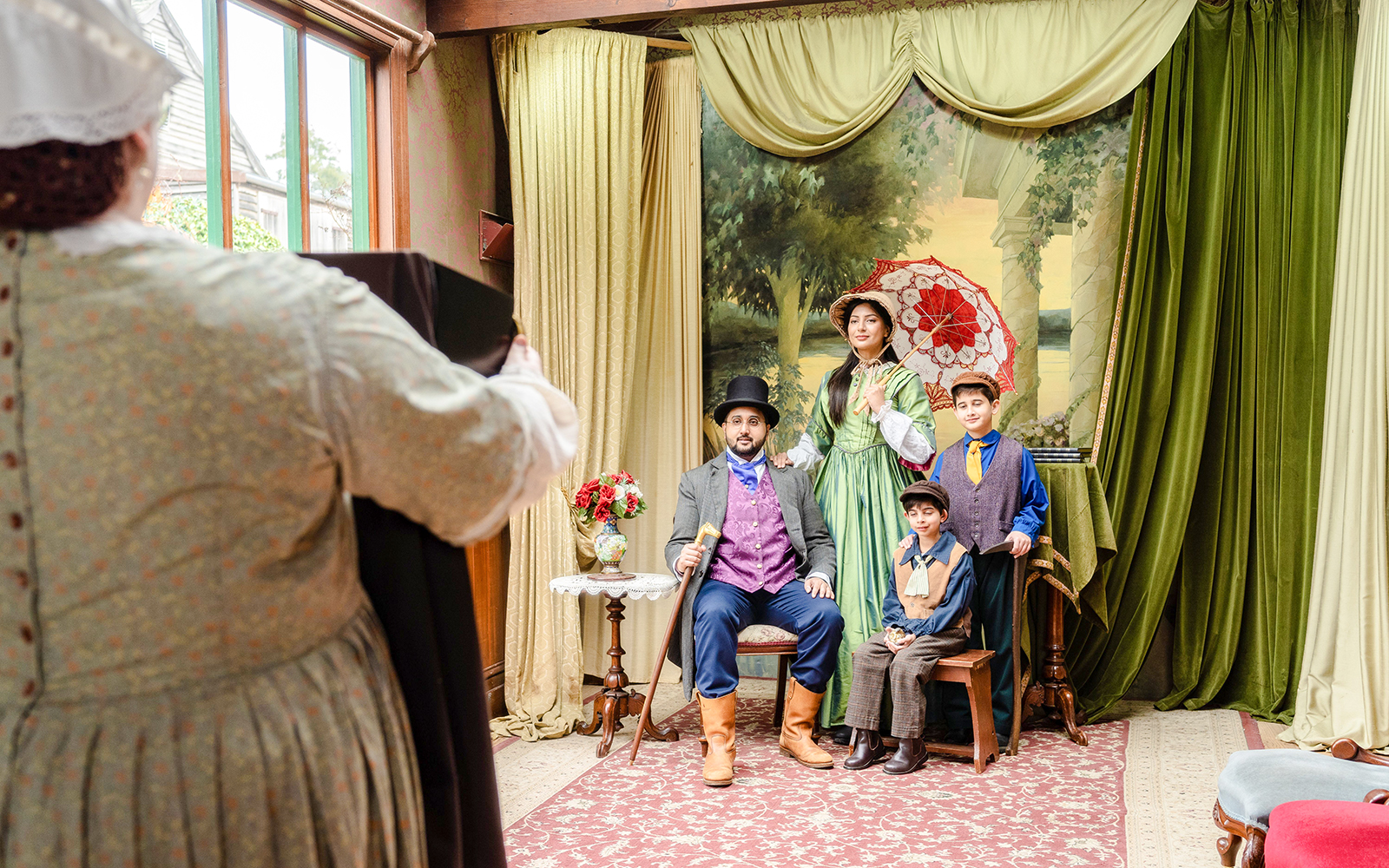 Family posing in Victorian attire at Sovereign Hill Museum.