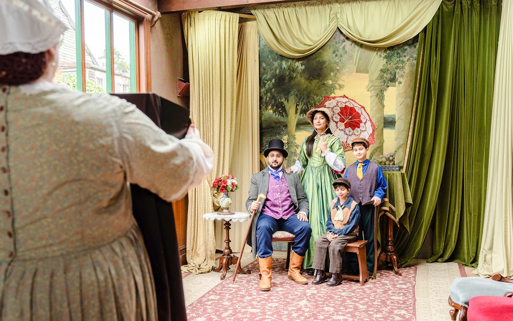 Family posing in Victorian attire at Sovereign Hill Museum.