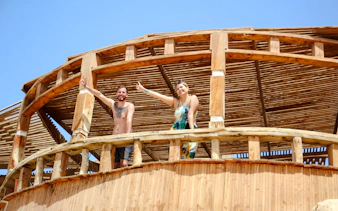 Visitors enjoying a wooden deck on the Giftun 3 Islands Tour.
