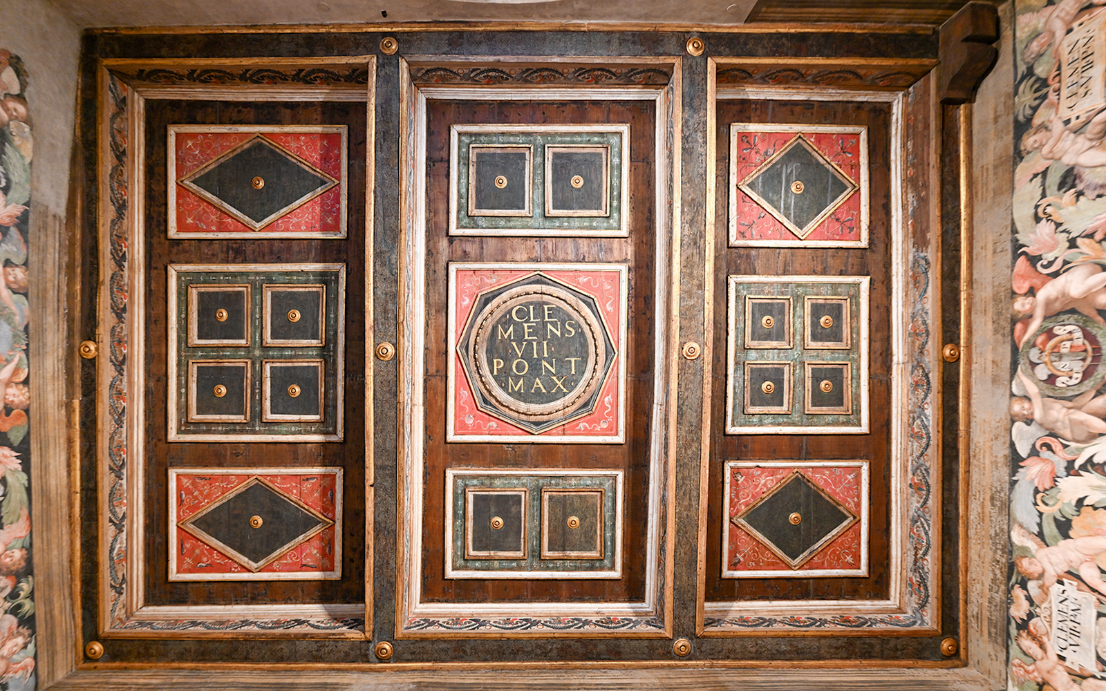 Ceiling details of Castel Sant'Angelo interior featuring ornate geometric patterns and inscriptions.