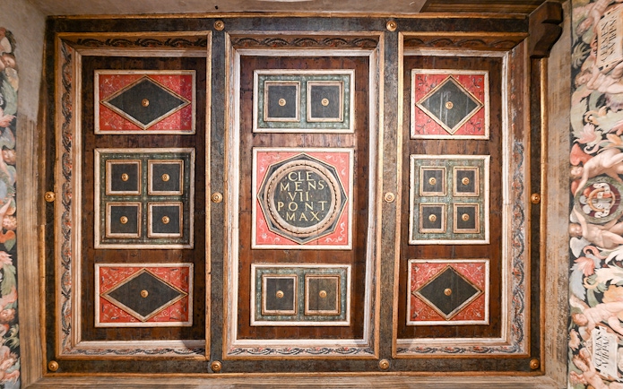 Ceiling details of Castel Sant'Angelo interior featuring ornate geometric patterns and inscriptions.