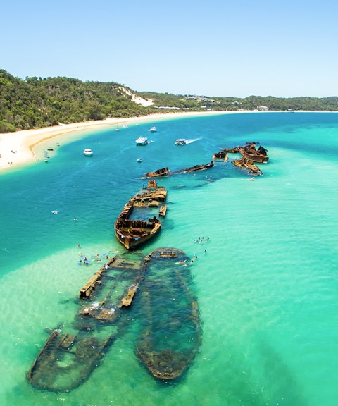 Aerial view of shipwrecks in turquoise waters off Moreton Island, Queensland, Australia.
