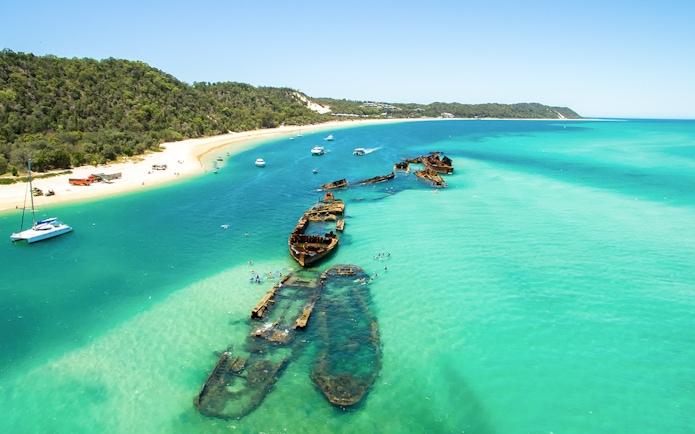 Aerial view of shipwrecks in turquoise waters off Moreton Island, Queensland, Australia.