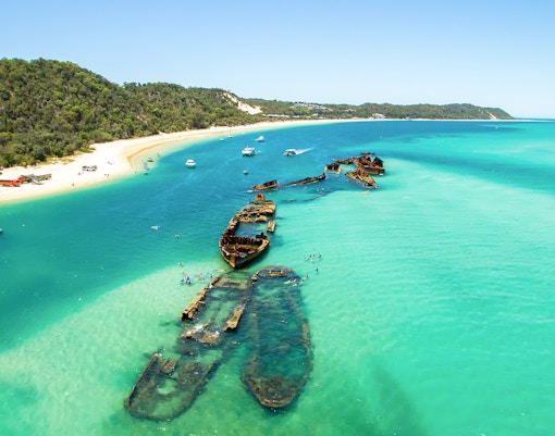 Aerial view of shipwrecks in turquoise waters off Moreton Island, Queensland, Australia.