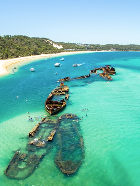Aerial view of shipwrecks in turquoise waters off Moreton Island, Queensland, Australia.