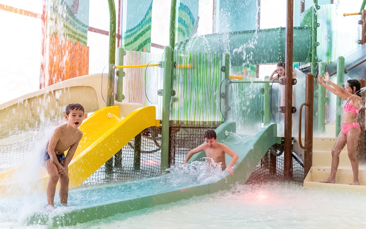 Children playing on water slides at Kiddie Bay, Aqualibi.