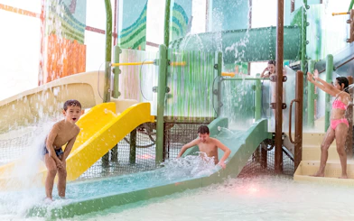 Children playing on water slides at Kiddie Bay, Aqualibi.