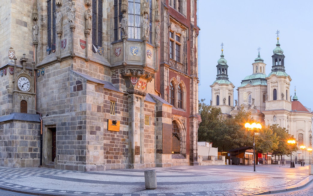 St. Nicholas Church in Prague with its baroque architecture and nearby street lamps.