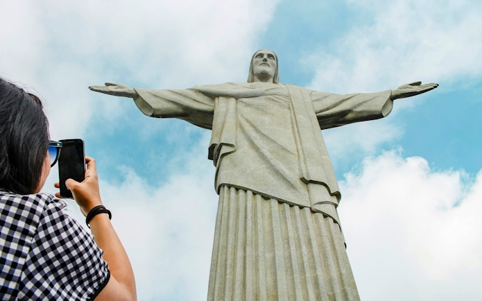 Person photographing Christ the Redeemer statue in Rio de Janeiro.