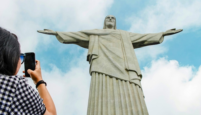 Person photographing Christ the Redeemer statue in Rio de Janeiro.