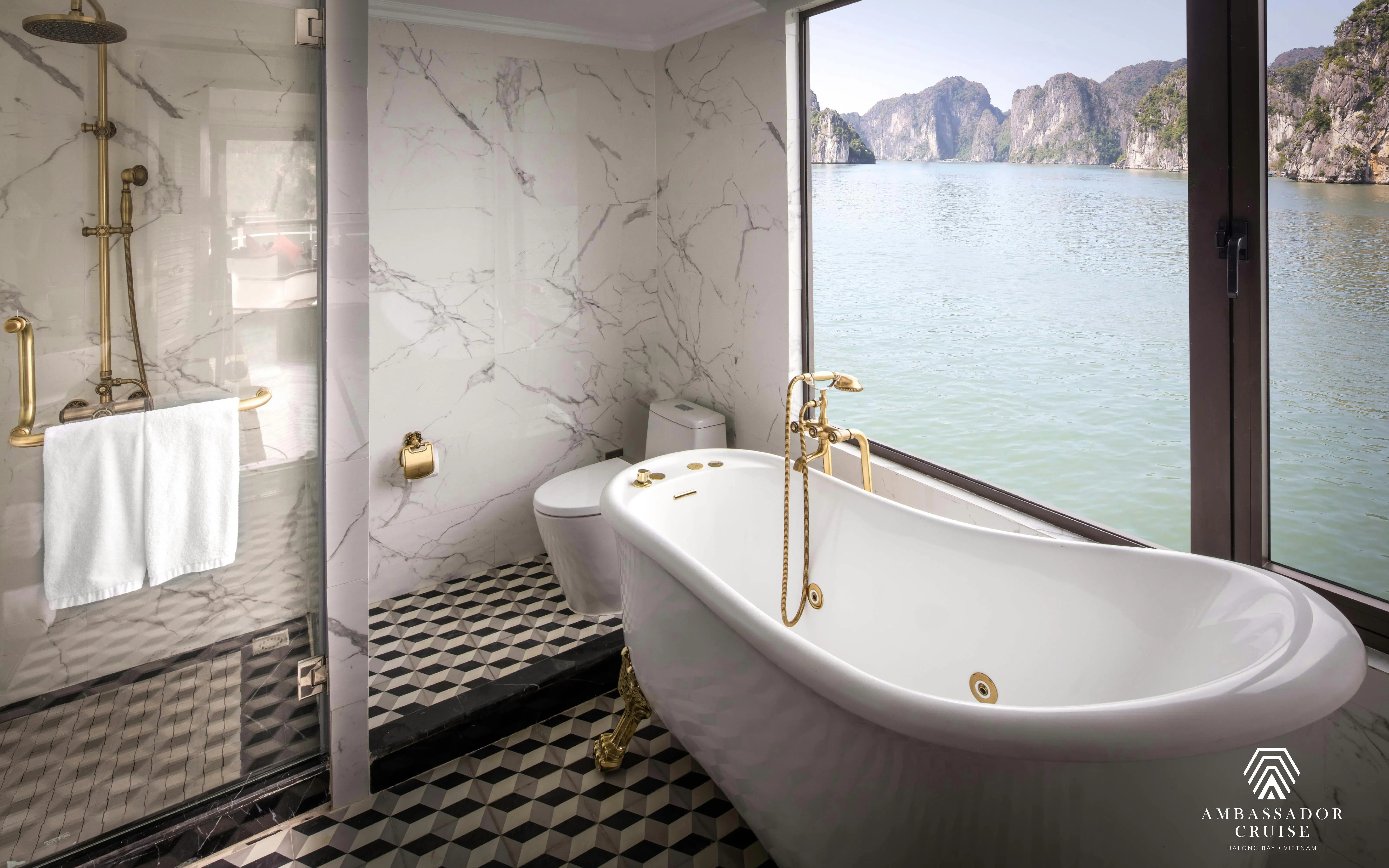 Luxurious bathroom with a view of Ha Long Bay on a 5-star Ambassador Cruise.