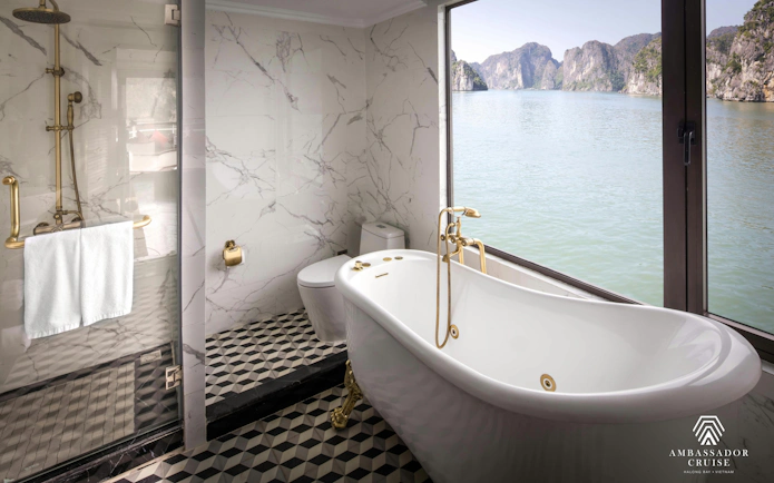 Luxurious bathroom with a view of Ha Long Bay on a 5-star Ambassador Cruise.