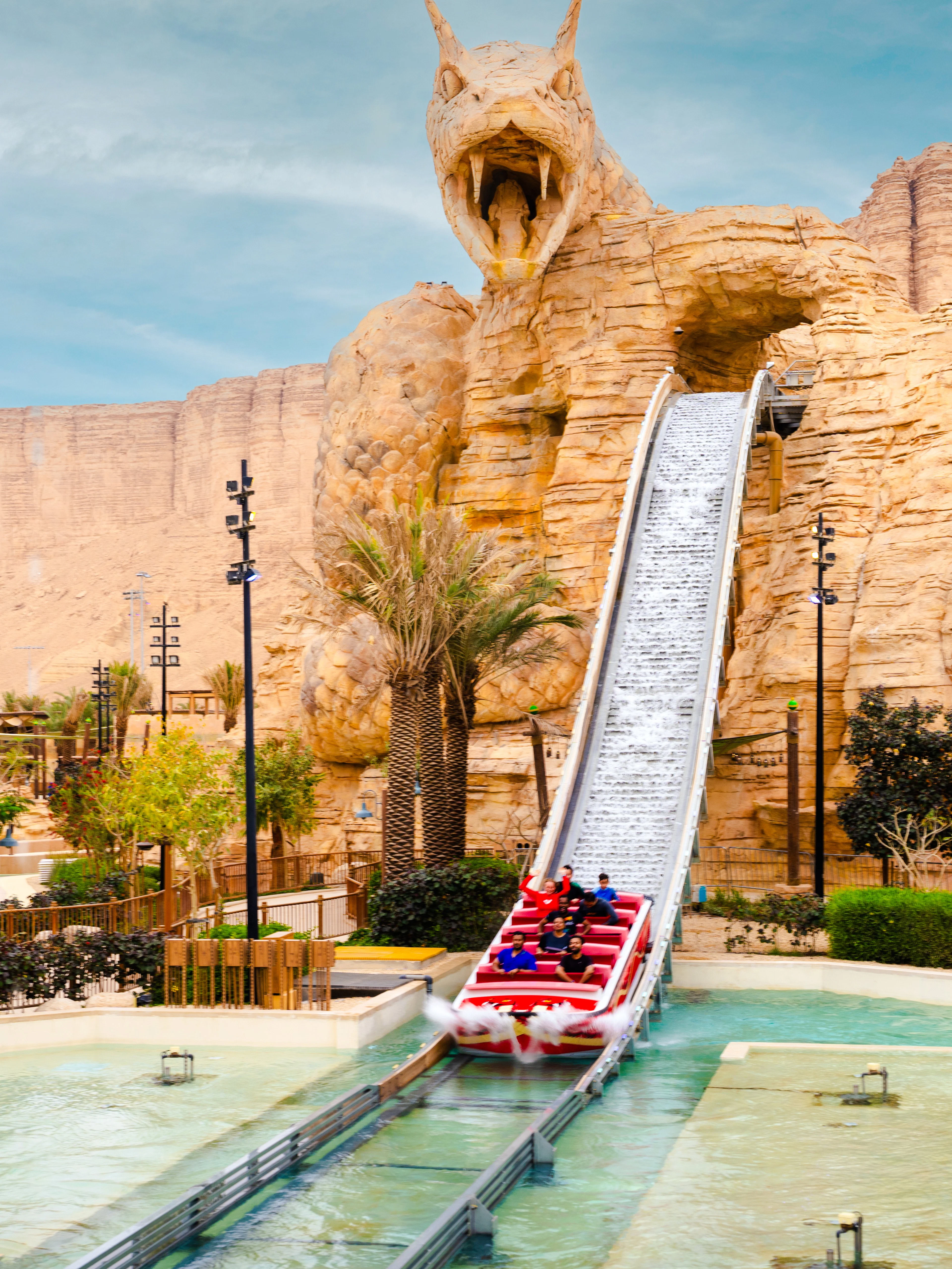 Water ride descending from dragon-themed structure at Aquarabia Qiddiya.
