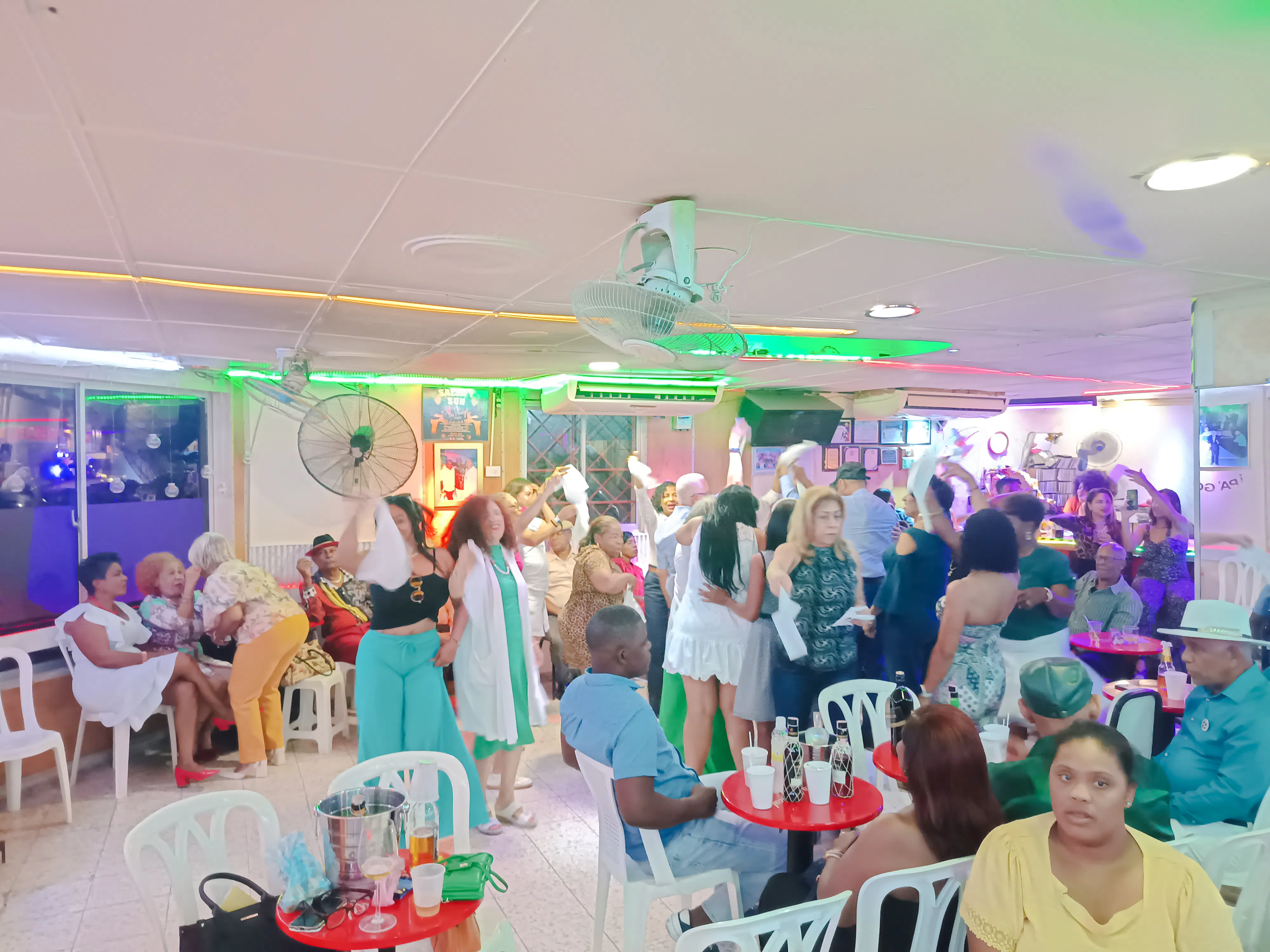 People enjoying live Caribbean music and dancing in a vibrant venue in Santo Domingo, Punta Cana.