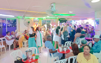 People enjoying live Caribbean music and dancing in a vibrant venue in Santo Domingo, Punta Cana.