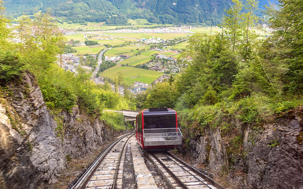 Train descending through lush mountains on the way to Interlaken from Zürich.