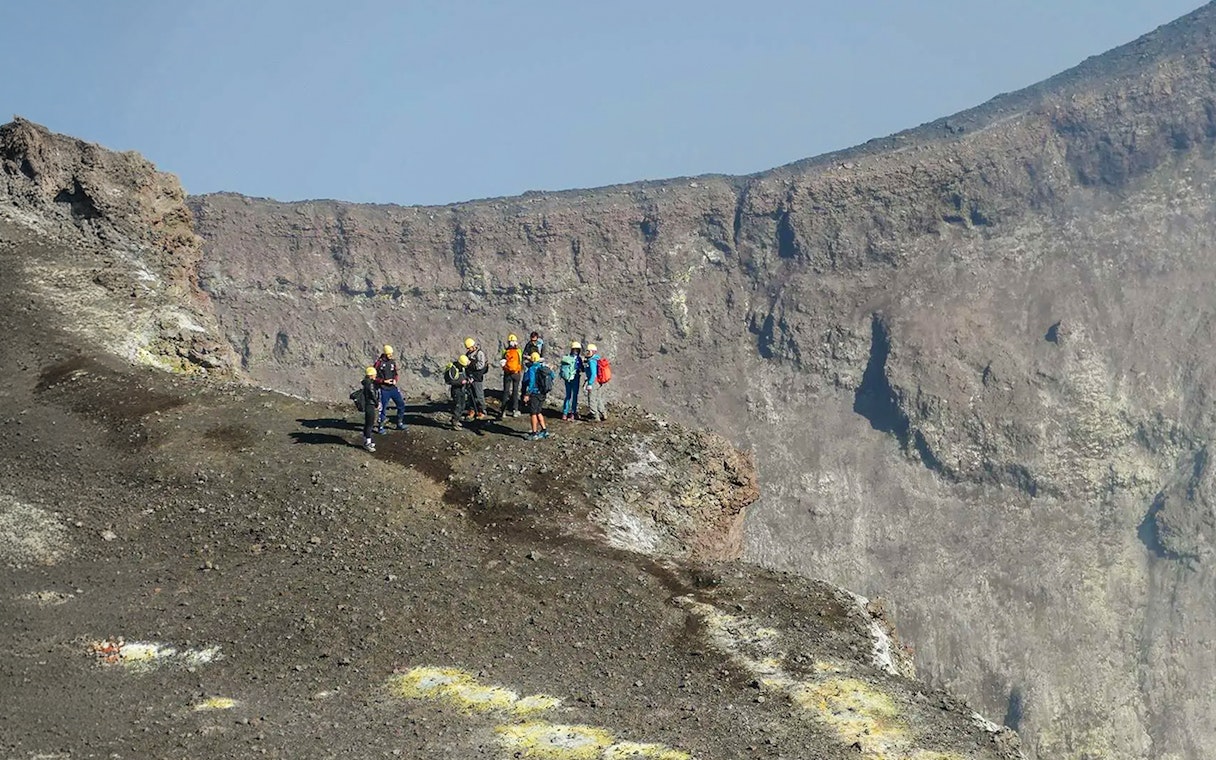 Group of hikers on Mount Etna's summit during a guided trek.