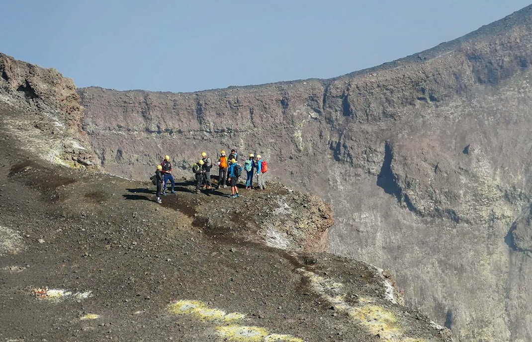 Group of hikers on Mount Etna's summit during a guided trek.