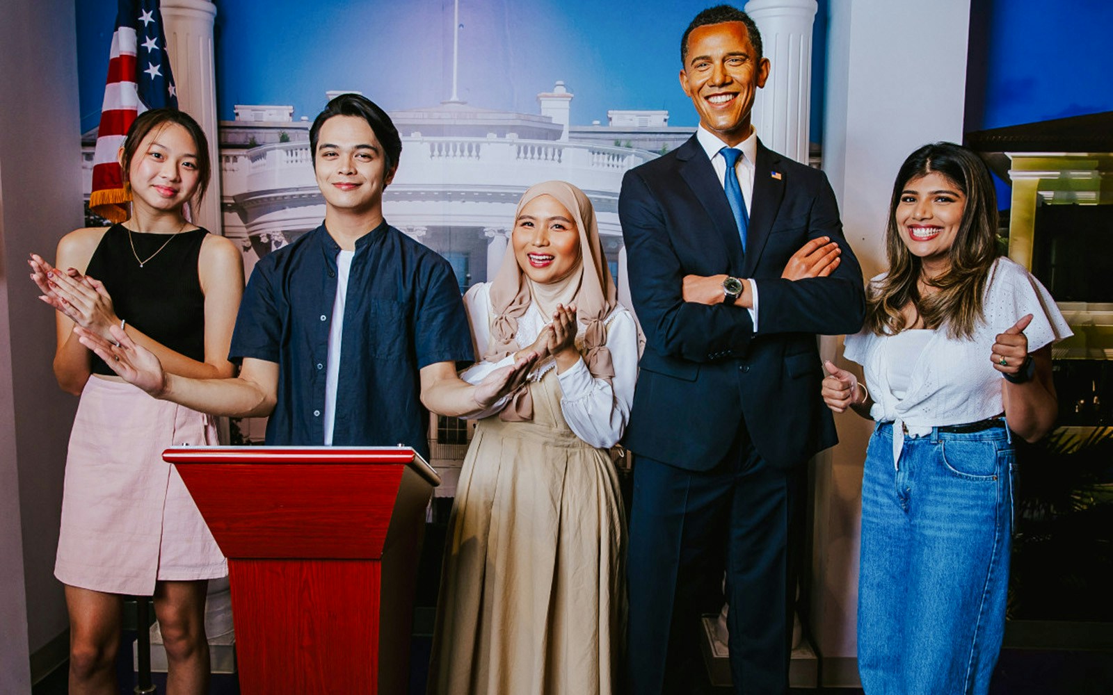 Visitors with Obama wax figure at Madame Tussauds Singapore.