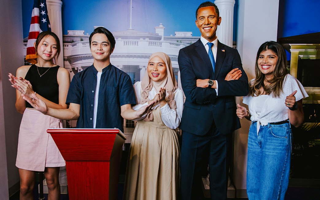 Visitors with Obama wax figure at Madame Tussauds Singapore.