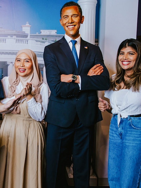 Visitors with Obama wax figure at Madame Tussauds Singapore.