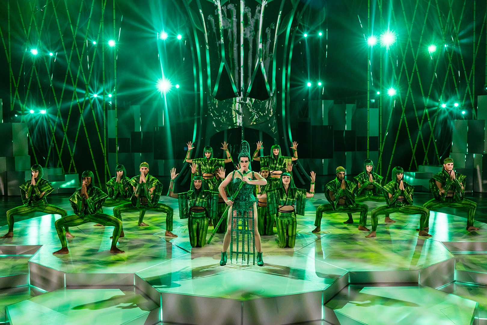 Performers in green costumes on stage at FALLING | IN LOVE Grand Show.