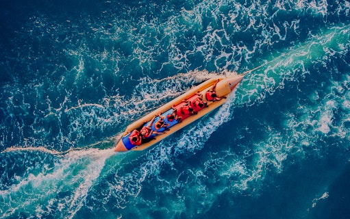 People enjoying a banana boat ride on the ocean.