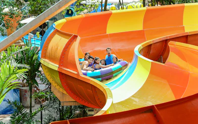 Group enjoying a colorful water ride at Sunway Lagoon theme park.