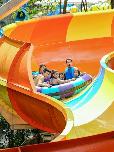 Group enjoying a colorful water ride at Sunway Lagoon theme park.