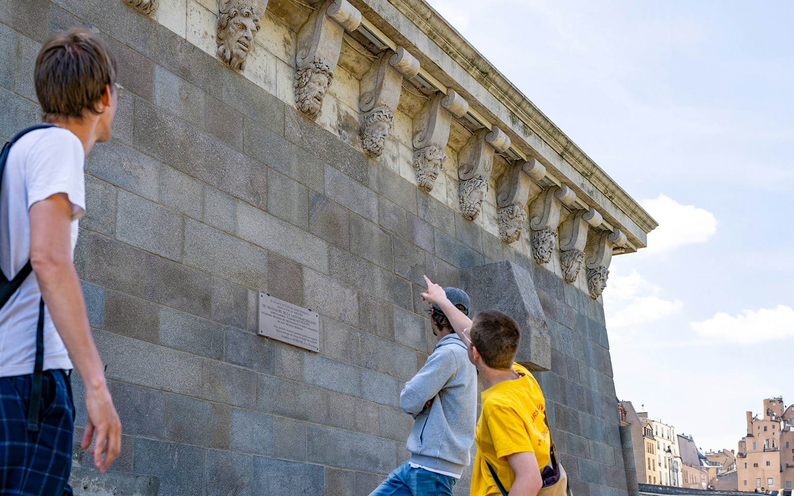 Notre Dame Cathedral facade with tourists on a guided walking tour in Paris.