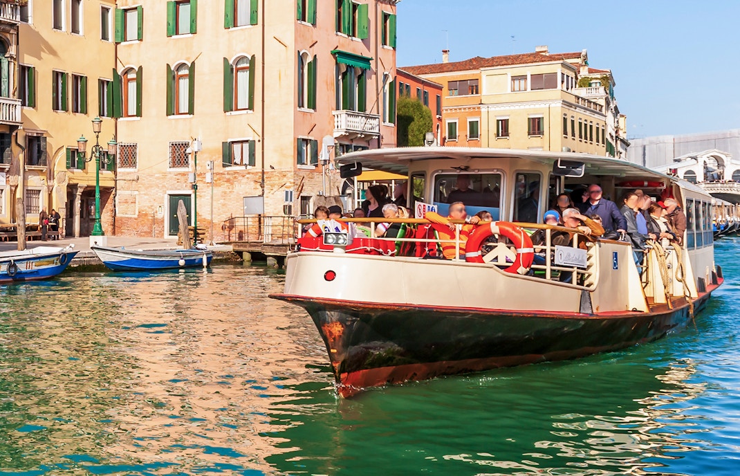 People riding a Vaporetto on the Grand Canal in Venice, Italy.