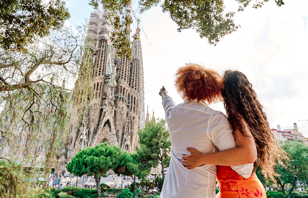 Tourists admiring the Sagrada Familia in Barcelona during summer.