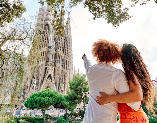 Tourists admiring the Sagrada Familia in Barcelona during summer.