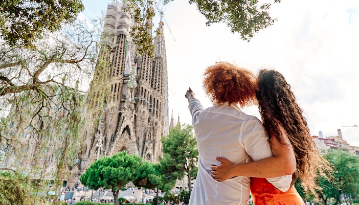 Tourists admiring the Sagrada Familia in Barcelona during summer.
