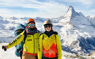 Tourist with guide on Zermatt mountain, Matterhorn in background.