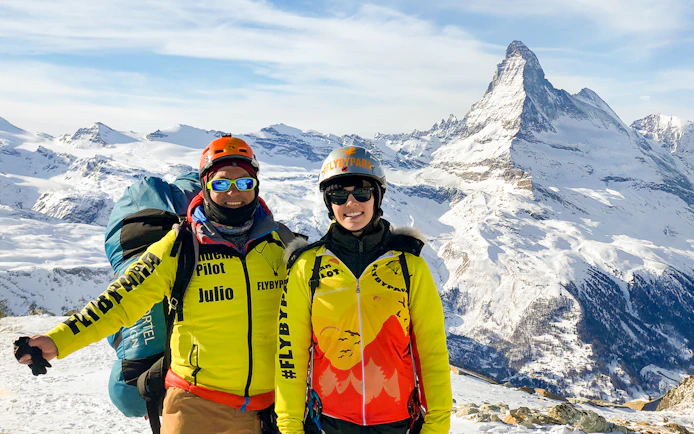 Tourist with guide on Zermatt mountain, Matterhorn in background.
