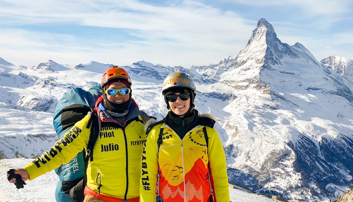 Tourist with guide on Zermatt mountain, Matterhorn in background.