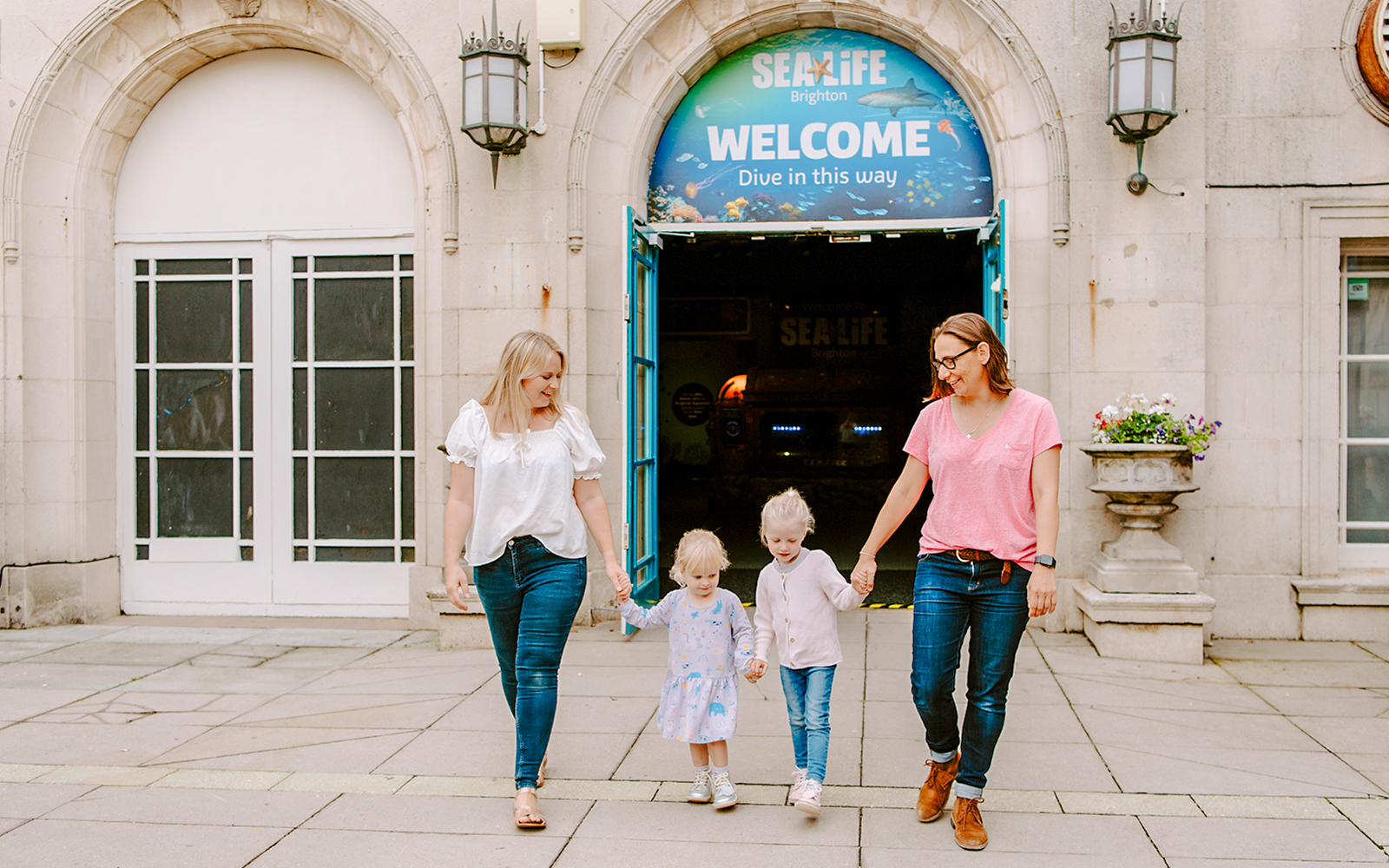 Guests exiting SEA LIFE Brighton with children.