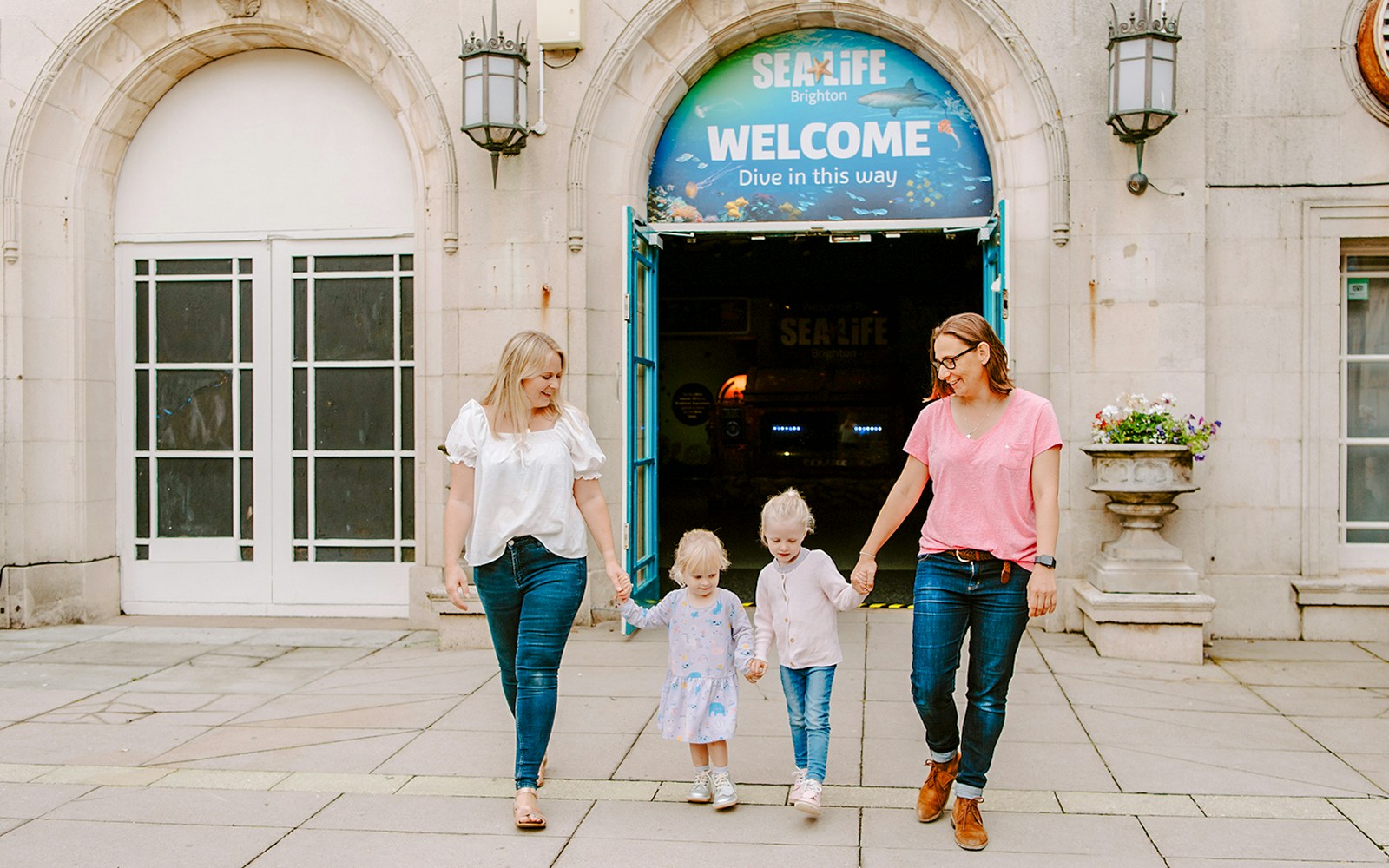 Guests exiting SEA LIFE Brighton with children.
