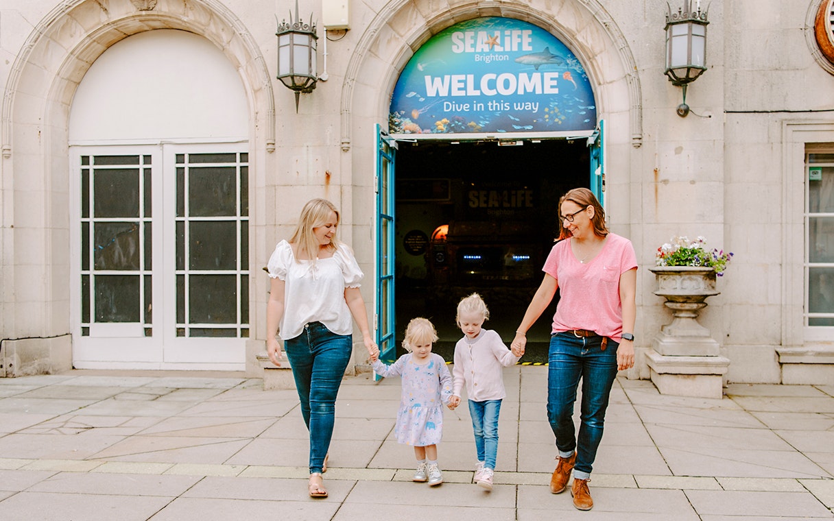 Guests exiting SEA LIFE Brighton with children.
