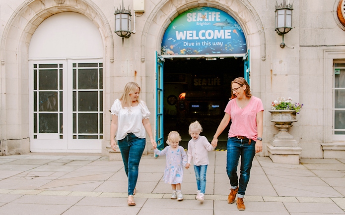 Guests exiting SEA LIFE Brighton with children.