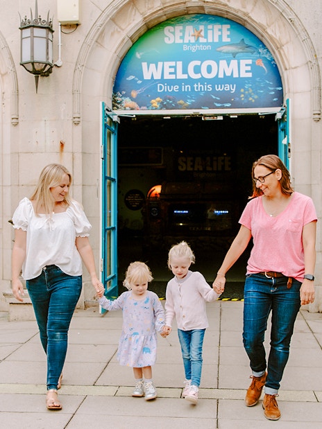 Guests exiting SEA LIFE Brighton with children.