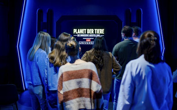Visitors viewing Planet Wildlife Immersive Exhibition display.