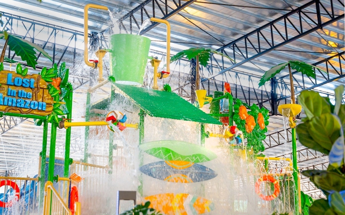 Water play area with large bucket splash at Monkeys Splash Zone, Lost in the Amazon theme.
