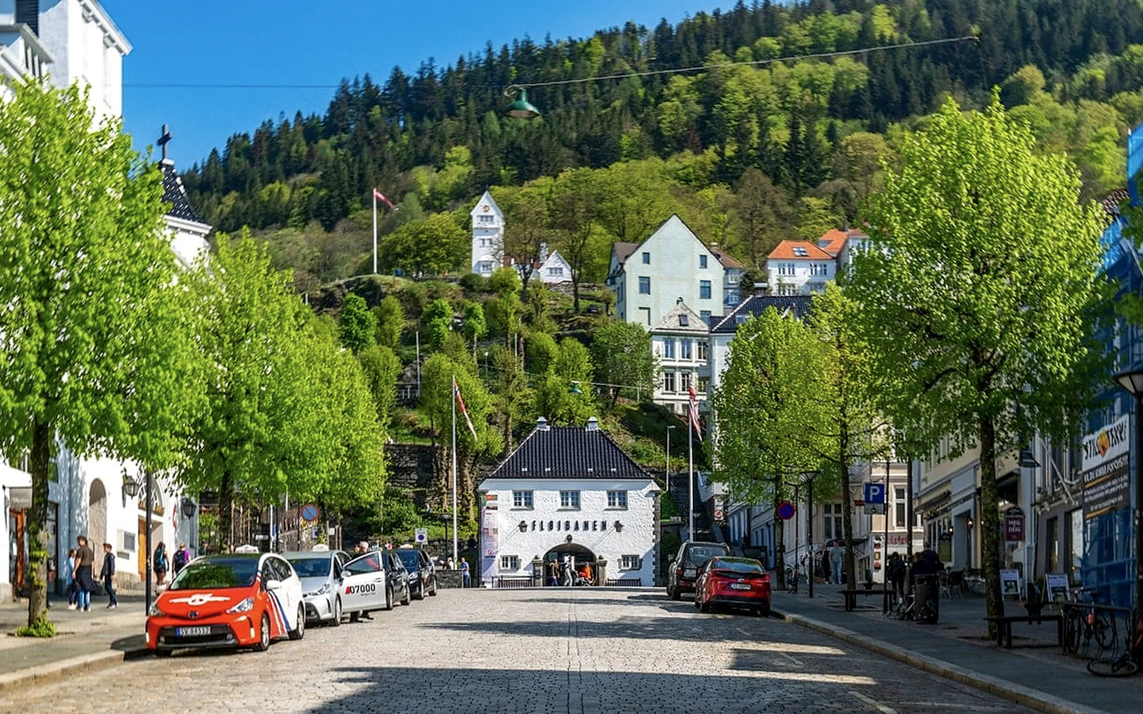 Lower station of the Fløibanen funicular in Bergen, Norway, with surrounding buildings and greenery.