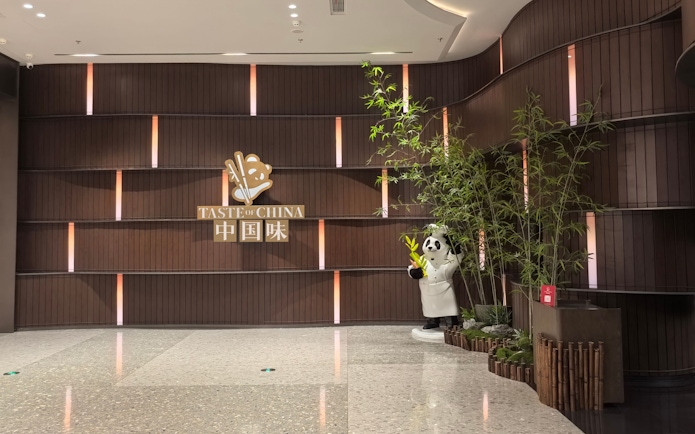 Lobby of TASTE OF CHINA restaurant in Shanghai with panda statue and bamboo decor.