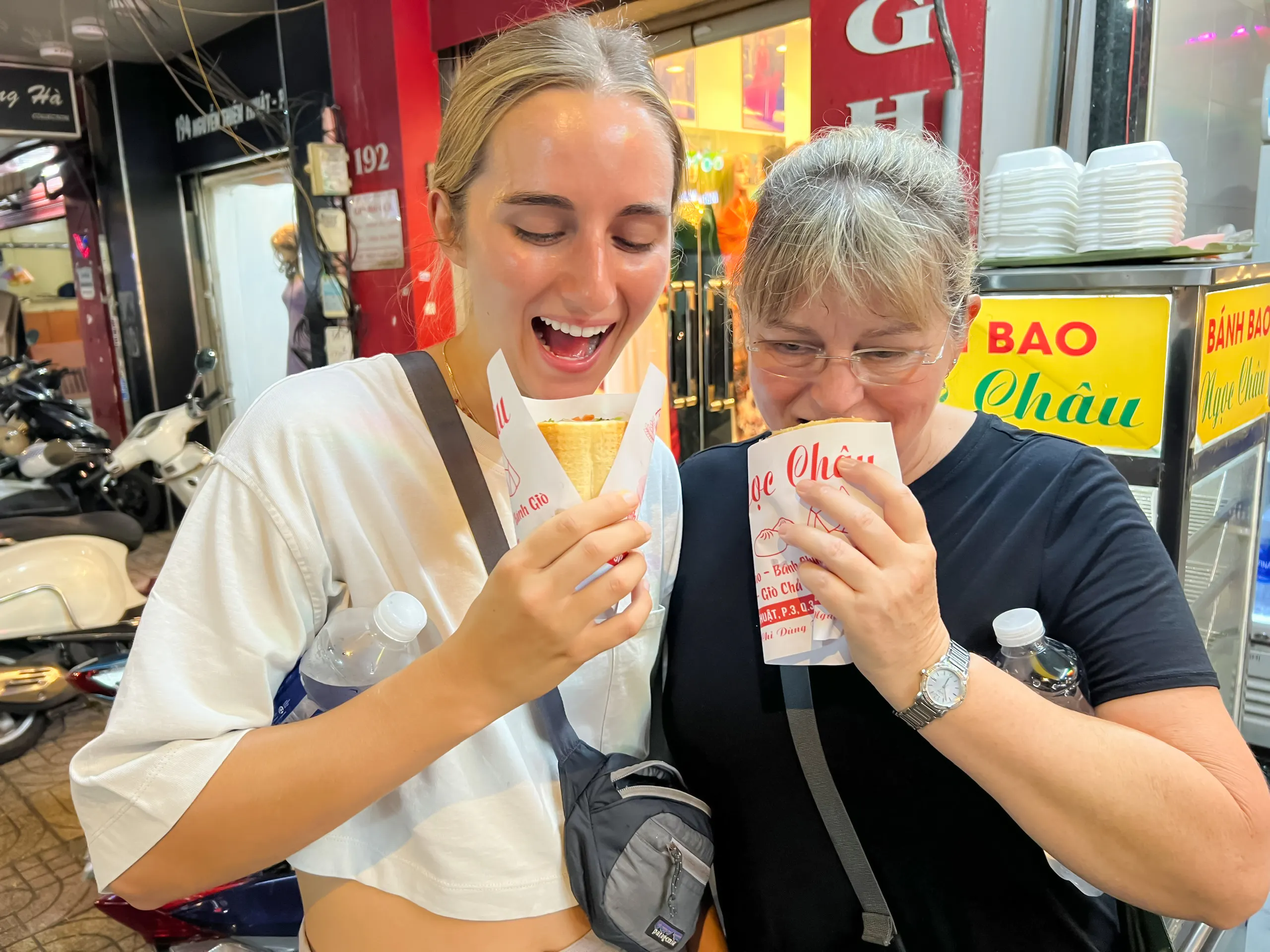 Tourists enjoying Vietnamese street food in Saigon, Ho Chi Minh City.
