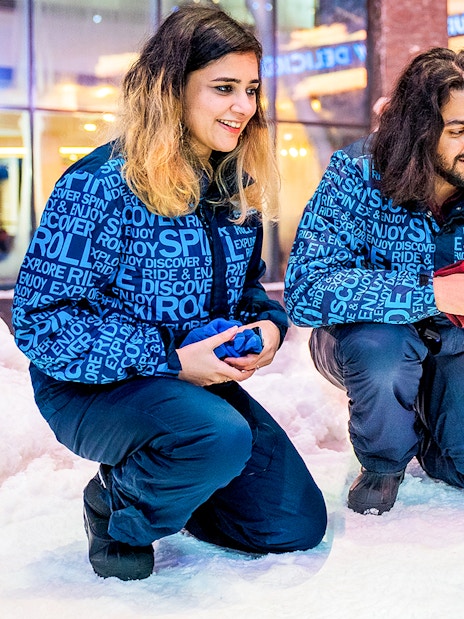 Visitors interacting with penguins at Ski Dubai Penguin Encounter.